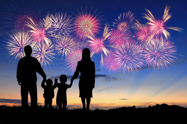 Family at Night Watching Fireworks in Sky