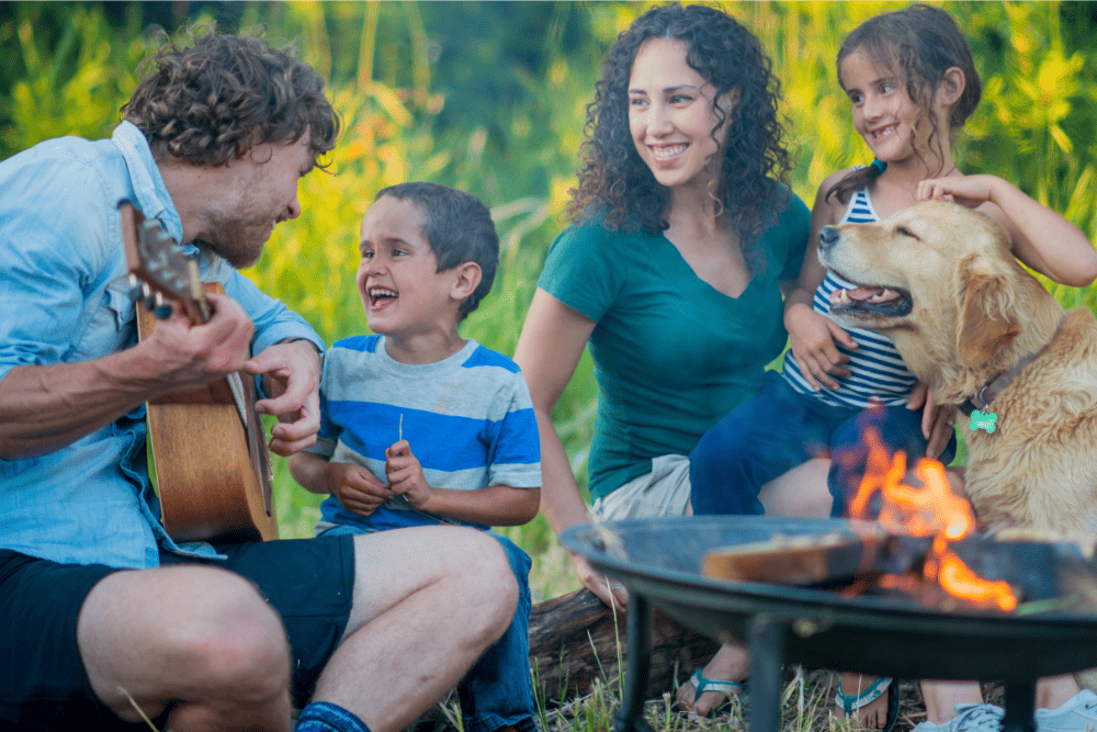 Family Making Smores Around Fire